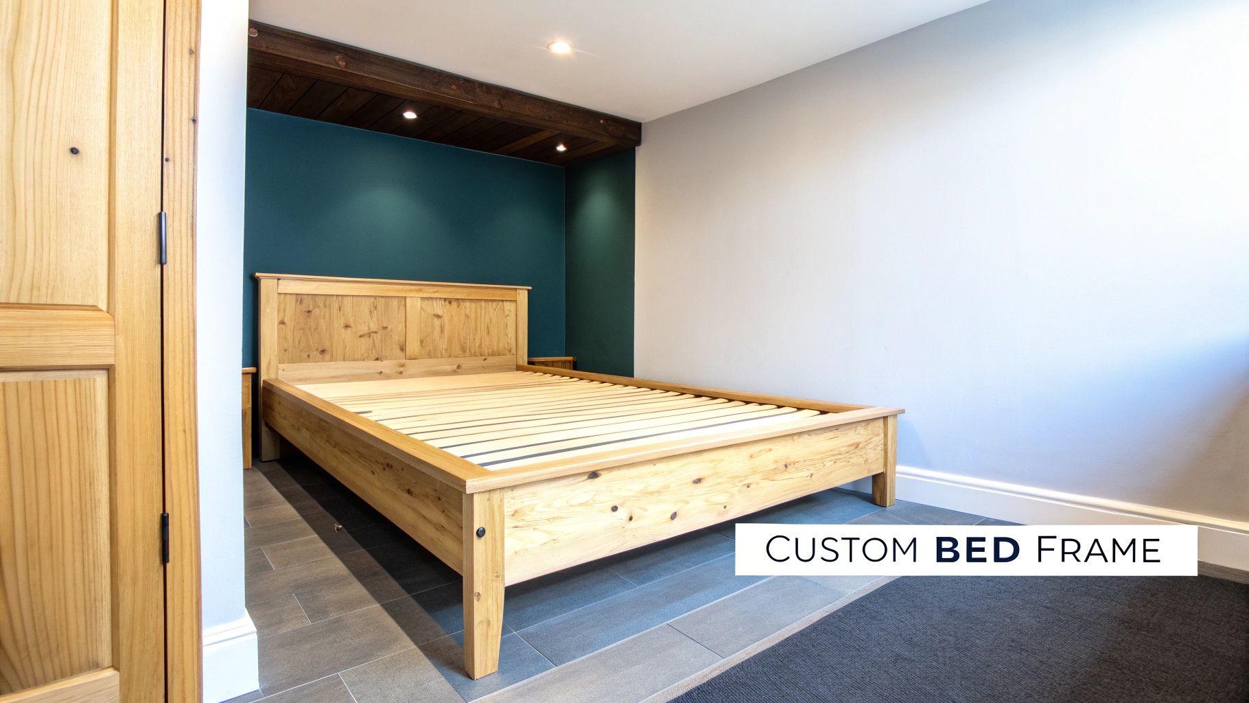 A beautiful custom light wood bed frame stands in a contemporary bedroom with a teal accent wall.