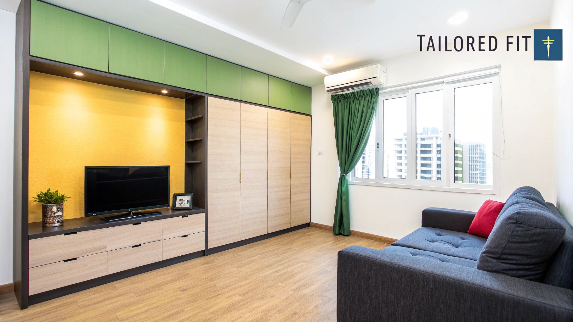 A modern living room featuring a yellow accent wall, customized wooden cabinetry, and a grey sofa.